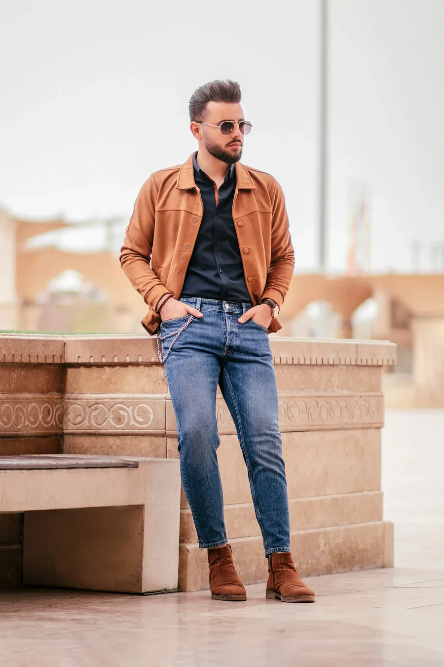 Man demonstrating a complementary color combination with a tan jacket and blue denim
